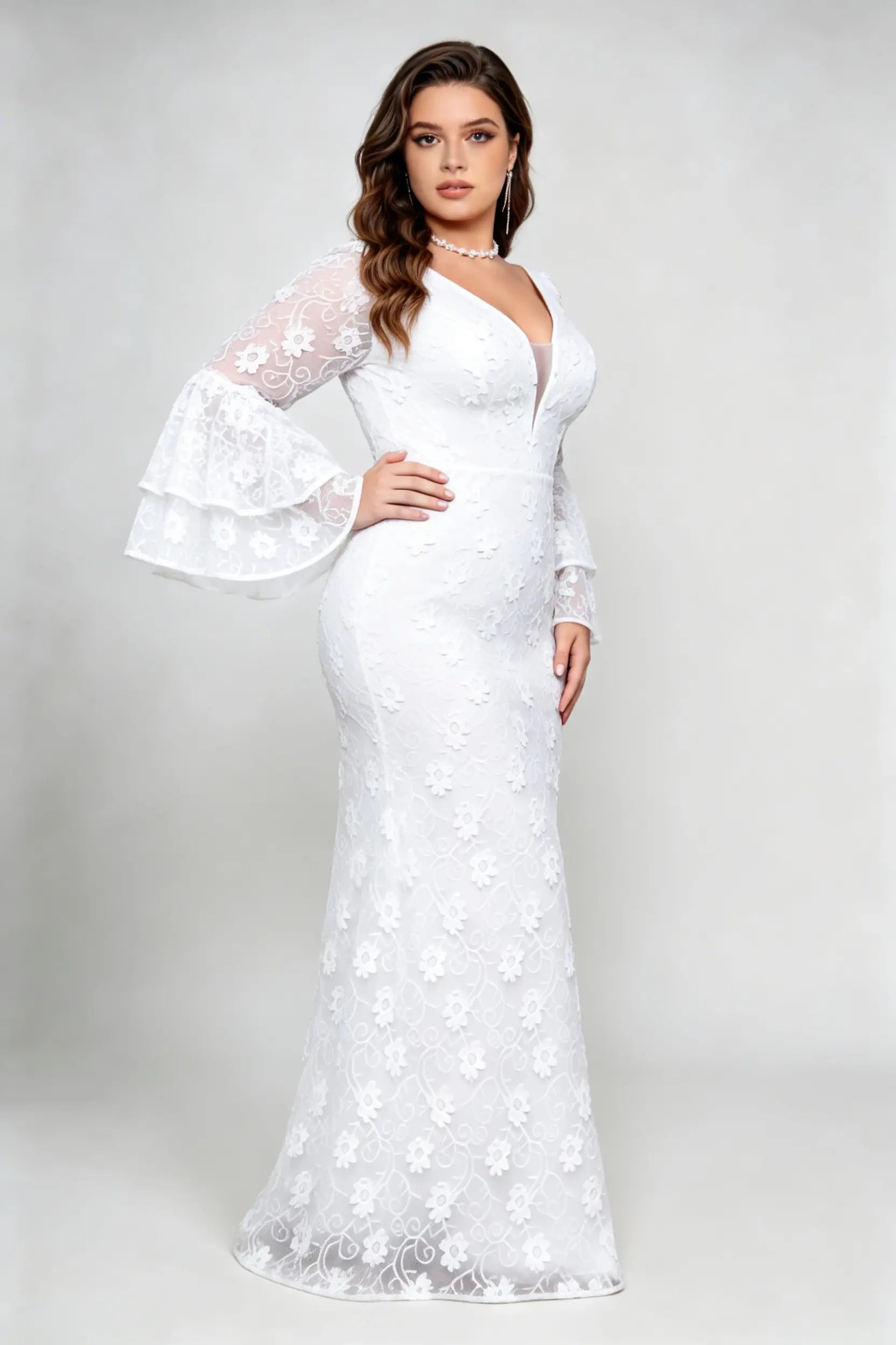 Curvy model wearing plus size v-neck white floral lace maxi dress with tiered bell sleeves
