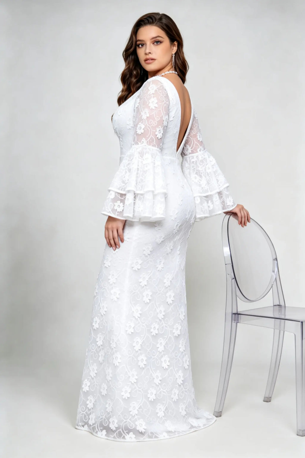 Curvy model wearing plus size v-neck white floral lace maxi dress with tiered bell sleeves