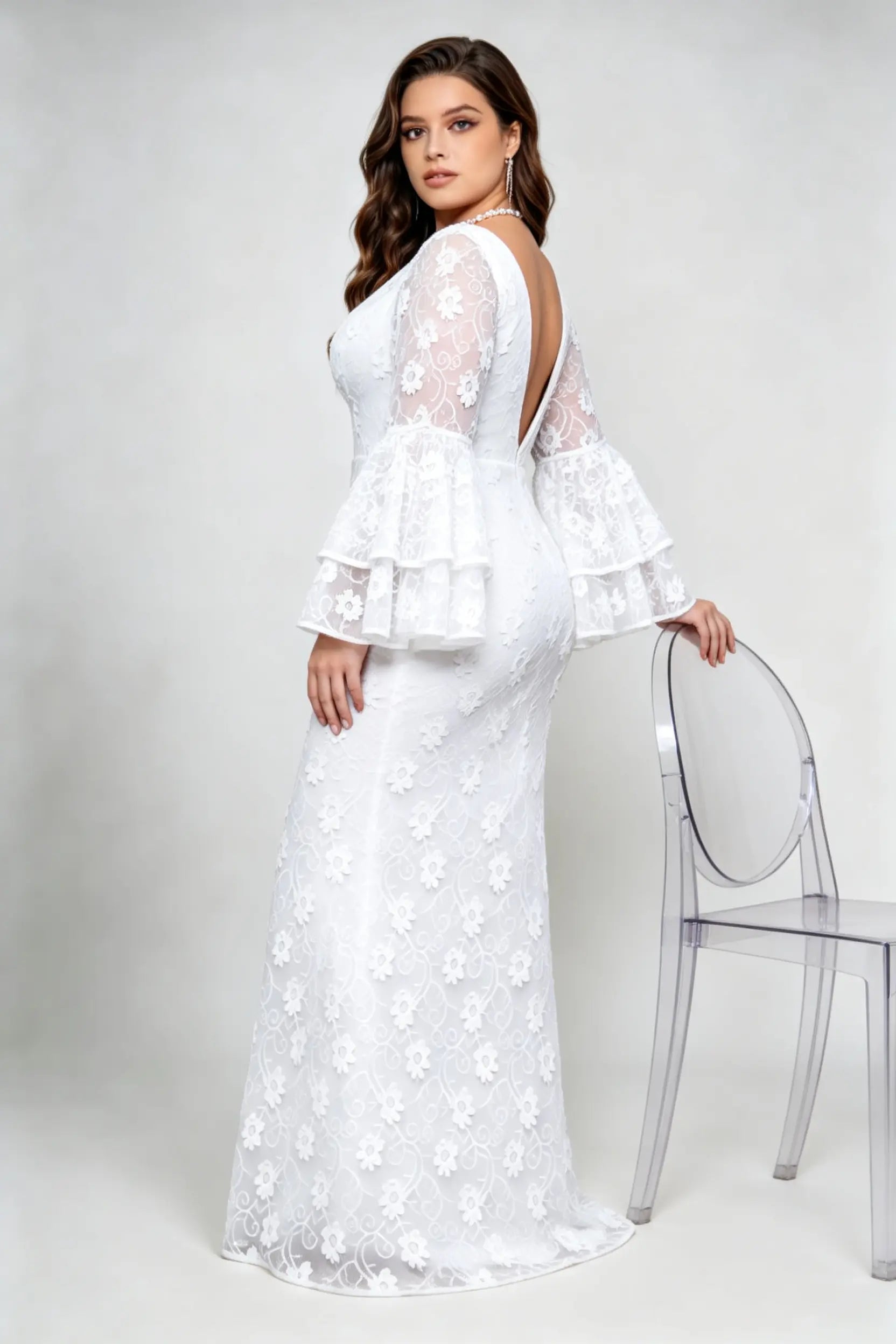 Curvy model wearing plus size v-neck white floral lace maxi dress with tiered bell sleeves