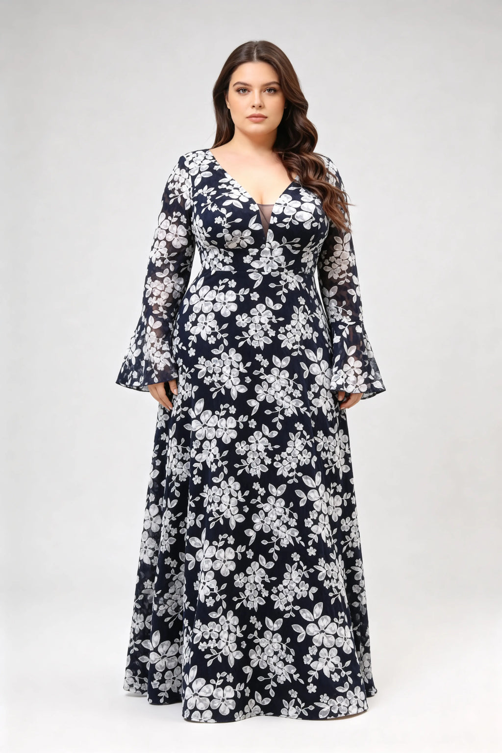 Curvy model wearing plus size navy blue lace floral evening gown - elegant deep v-neck long bell sleeve a-line maxi dress