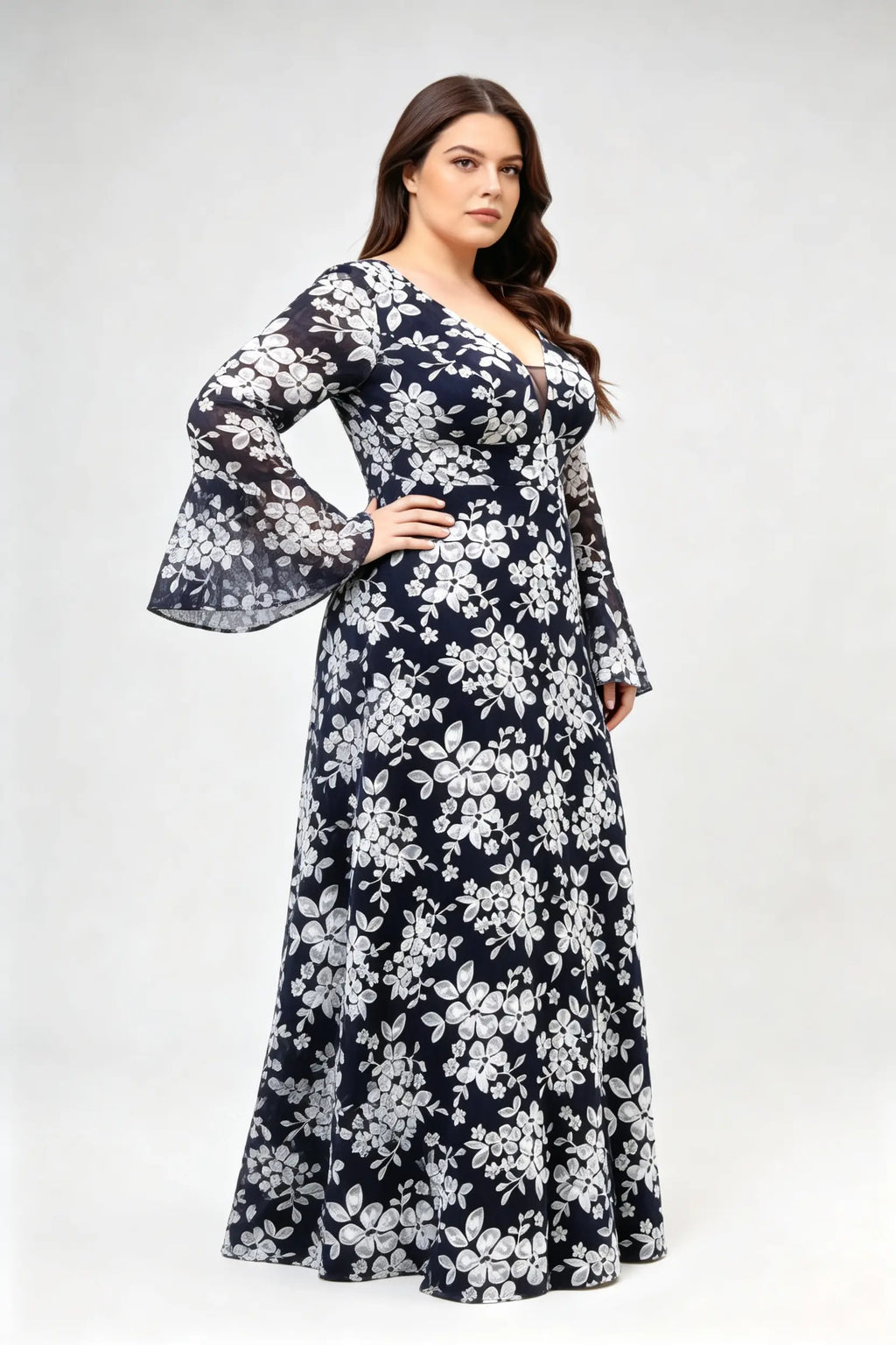 Curvy model wearing plus size navy blue lace floral evening gown - elegant deep v-neck long bell sleeve a-line maxi dress