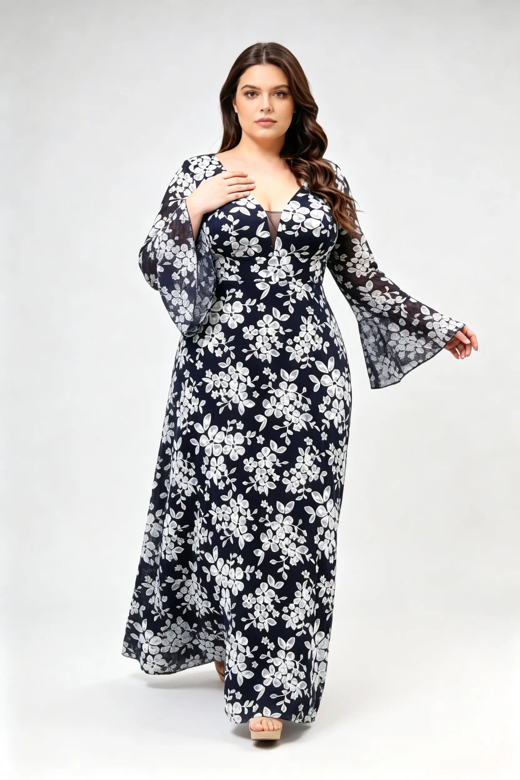 Curvy model wearing plus size navy blue lace floral evening gown - elegant deep v-neck long bell sleeve a-line maxi dress