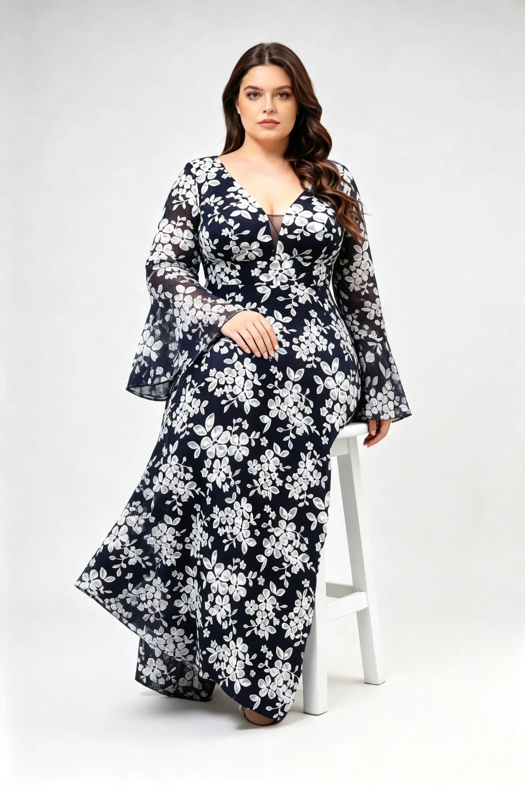 Curvy model wearing plus size navy blue lace floral evening gown - elegant deep v-neck long bell sleeve a-line maxi dress