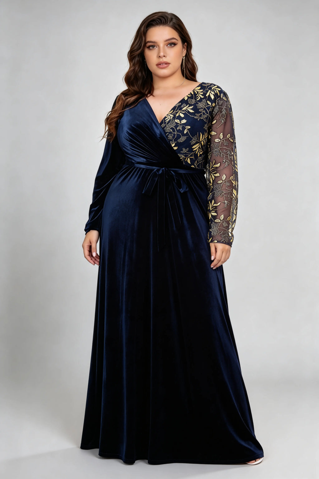 Curvy model wearing plus size asymmetrical gold embroidered navy blue velvet evening maxi dress