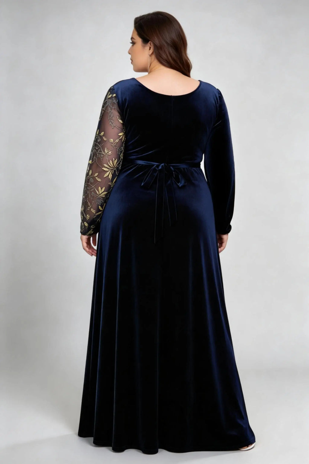 Curvy model wearing plus size asymmetrical gold embroidered navy blue velvet evening maxi dress
