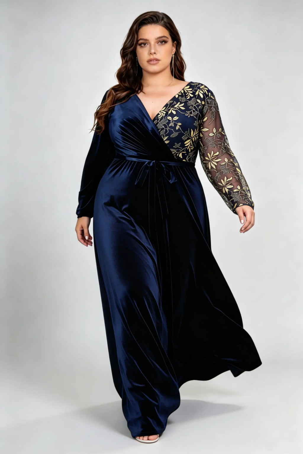 Curvy model wearing plus size asymmetrical gold embroidered navy blue velvet evening maxi dress