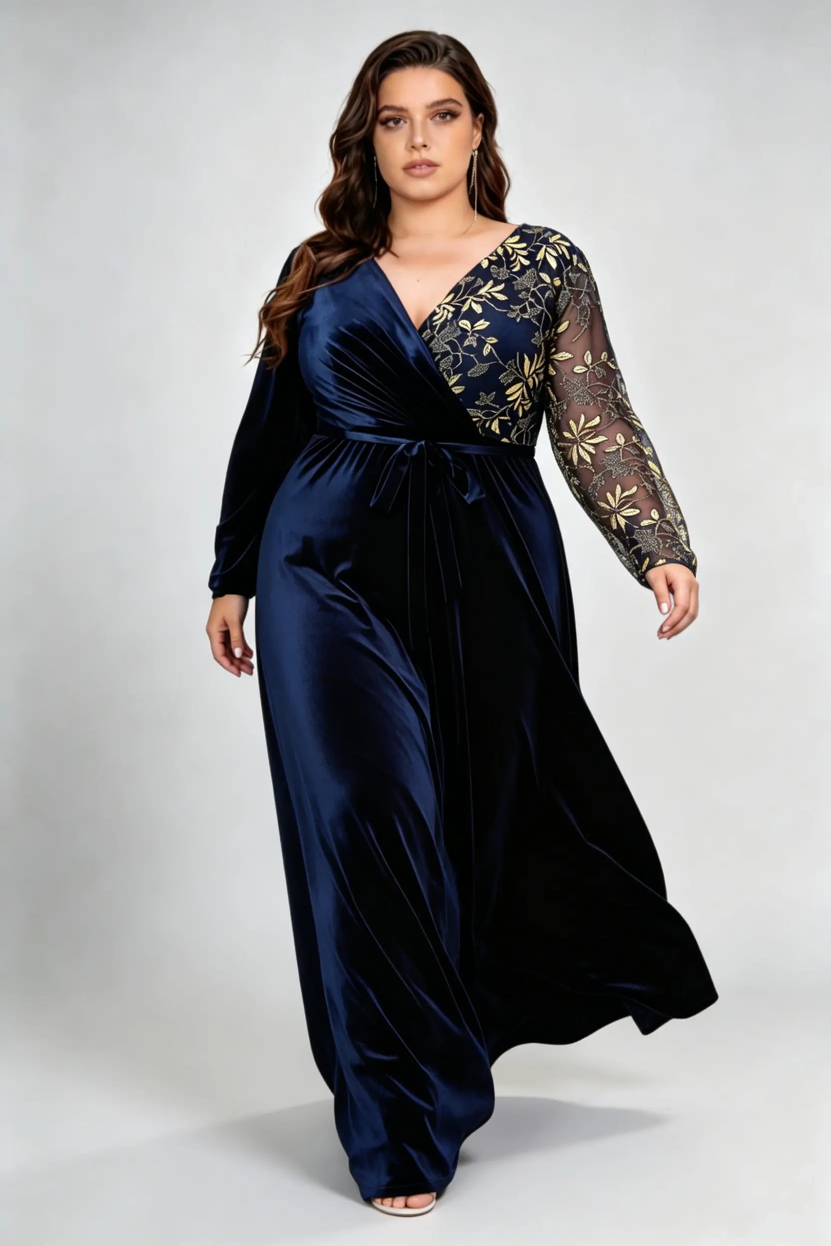 Curvy model wearing plus size asymmetrical gold embroidered navy blue velvet evening maxi dress