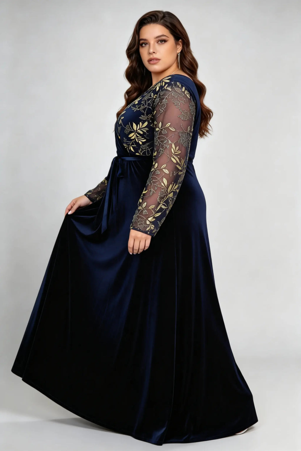 Curvy model wearing plus size asymmetrical gold embroidered navy blue velvet evening maxi dress
