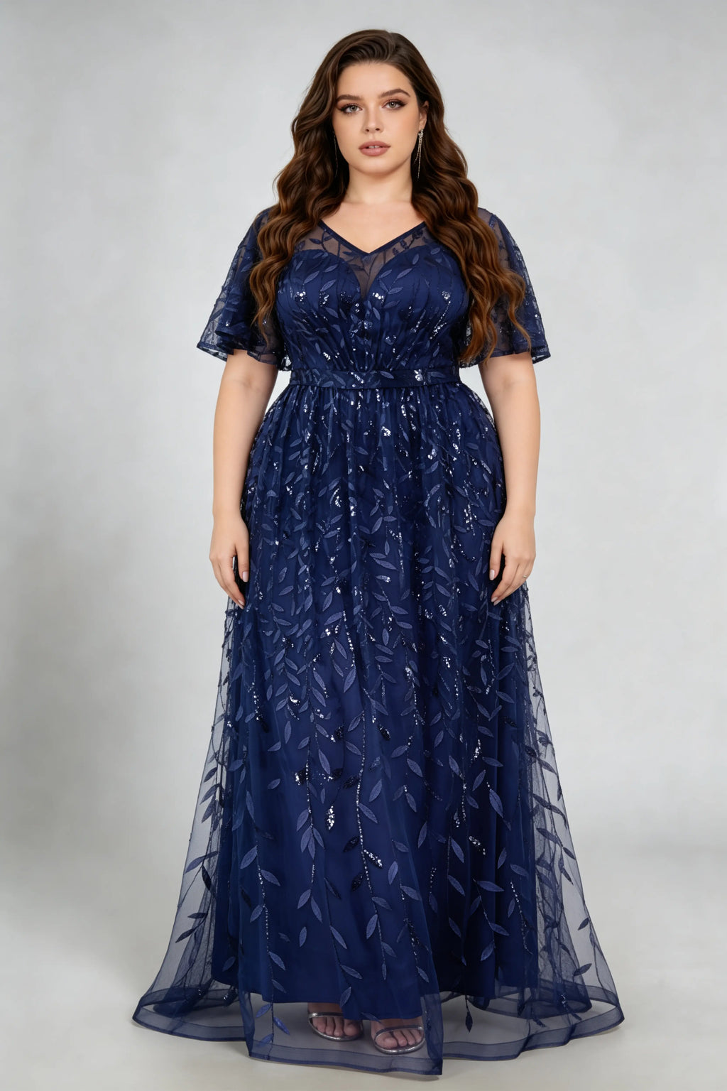 Curvy model wearing plus size navy sequined leaf flutter sleeve evening gown - elegant a-line prom & wedding guest maxi dress