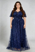 Curvy model wearing plus size navy sequined leaf flutter sleeve evening gown - elegant a-line prom & wedding guest maxi dress