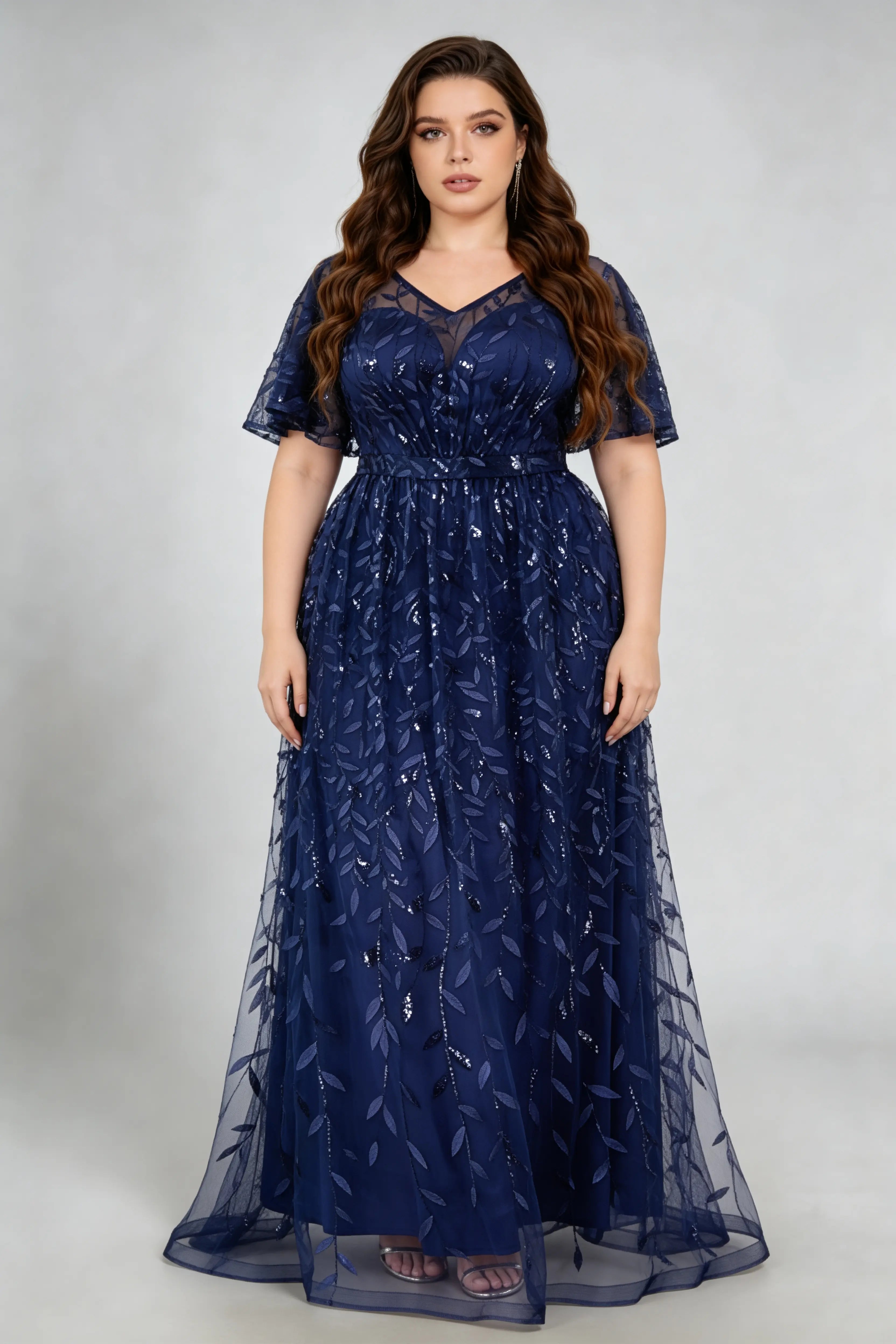 Curvy model wearing plus size navy sequined leaf flutter sleeve evening gown - elegant a-line prom & wedding guest maxi dress