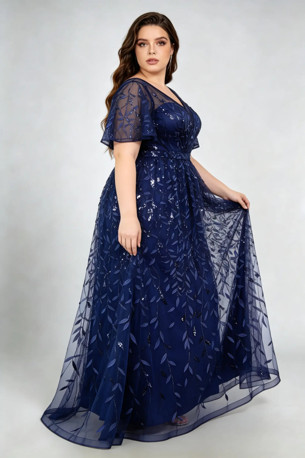 Curvy model wearing plus size navy sequined leaf flutter sleeve evening gown - elegant a-line prom & wedding guest maxi dress