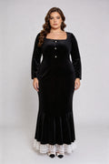 Curvy model wearing plus size black square neck velvet mermaid dress with lace trim hem