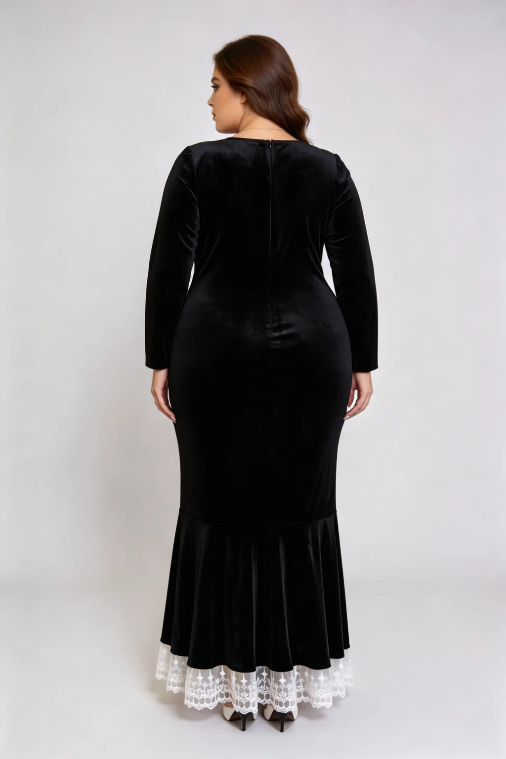 Curvy model wearing plus size black square neck velvet mermaid dress with lace trim hem