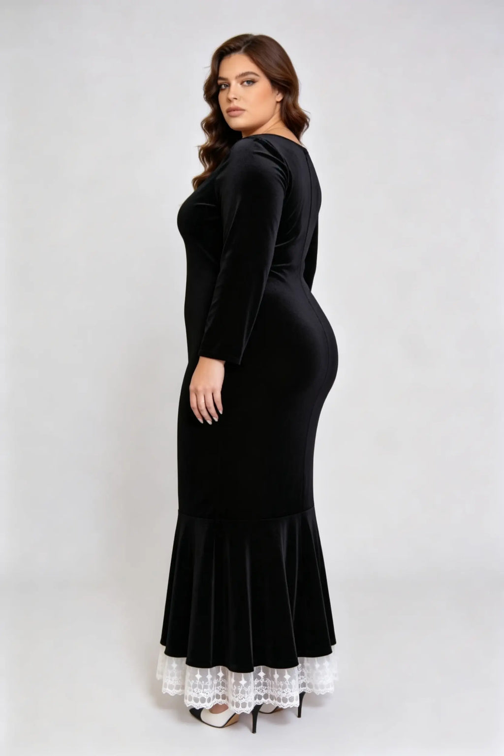 Curvy model wearing plus size black square neck velvet mermaid dress with lace trim hem