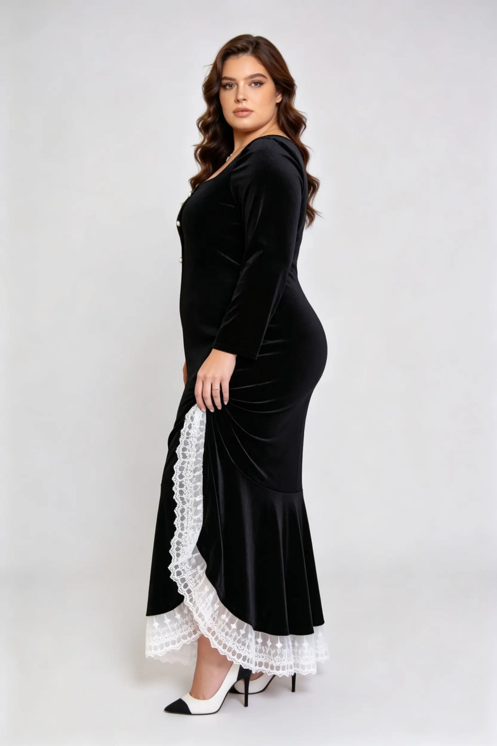 Curvy model wearing plus size black square neck velvet mermaid dress with lace trim hem