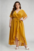 Curvy model wearing plus size mustard yellow velvet wrap high-low dress with swiss dot trim (xl-4xl)