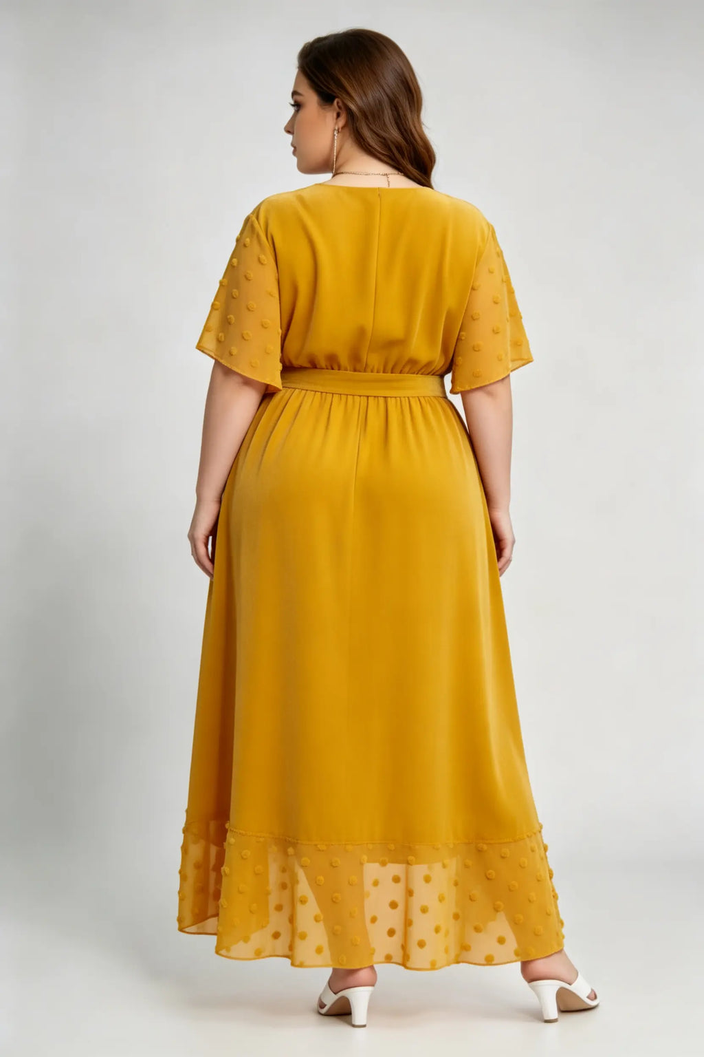 Curvy model wearing plus size mustard yellow velvet wrap high-low dress with swiss dot trim (xl-4xl)