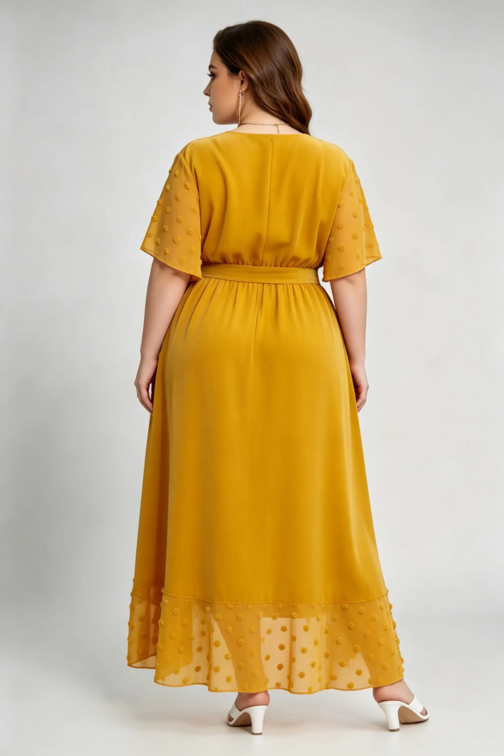 Curvy model wearing plus size mustard yellow velvet wrap high-low dress with swiss dot trim (xl-4xl)