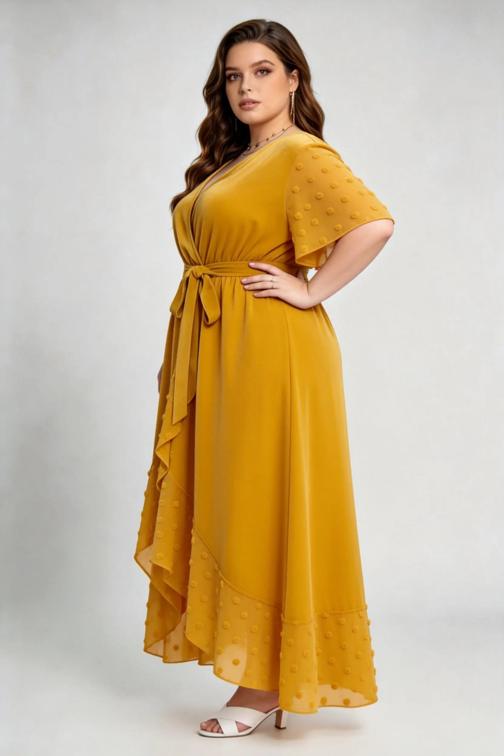 Curvy model wearing plus size mustard yellow velvet wrap high-low dress with swiss dot trim (xl-4xl)