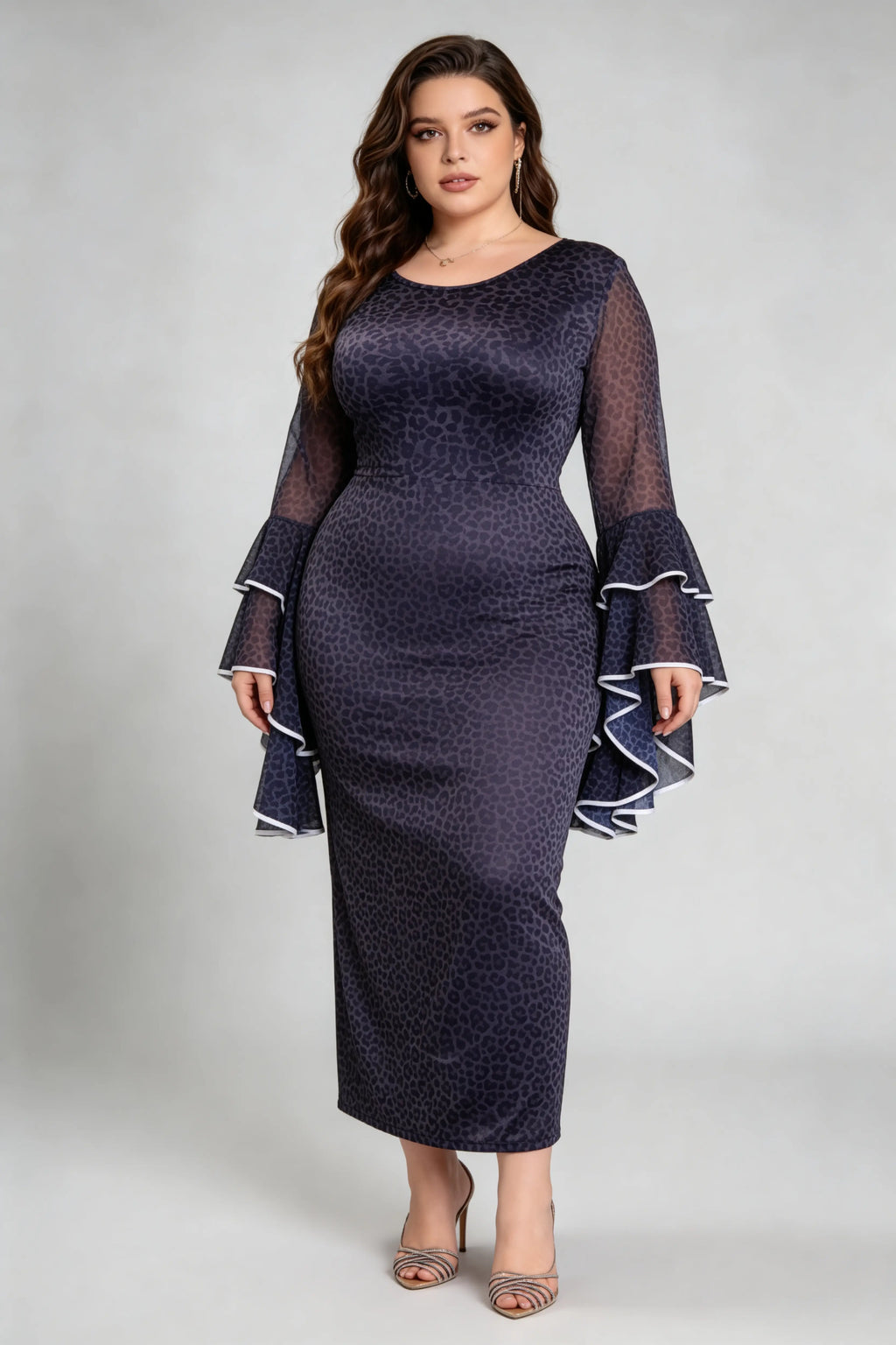 Curvy model wearing plus size black leopard print bodycon maxi dress with dramatic bell sleeves