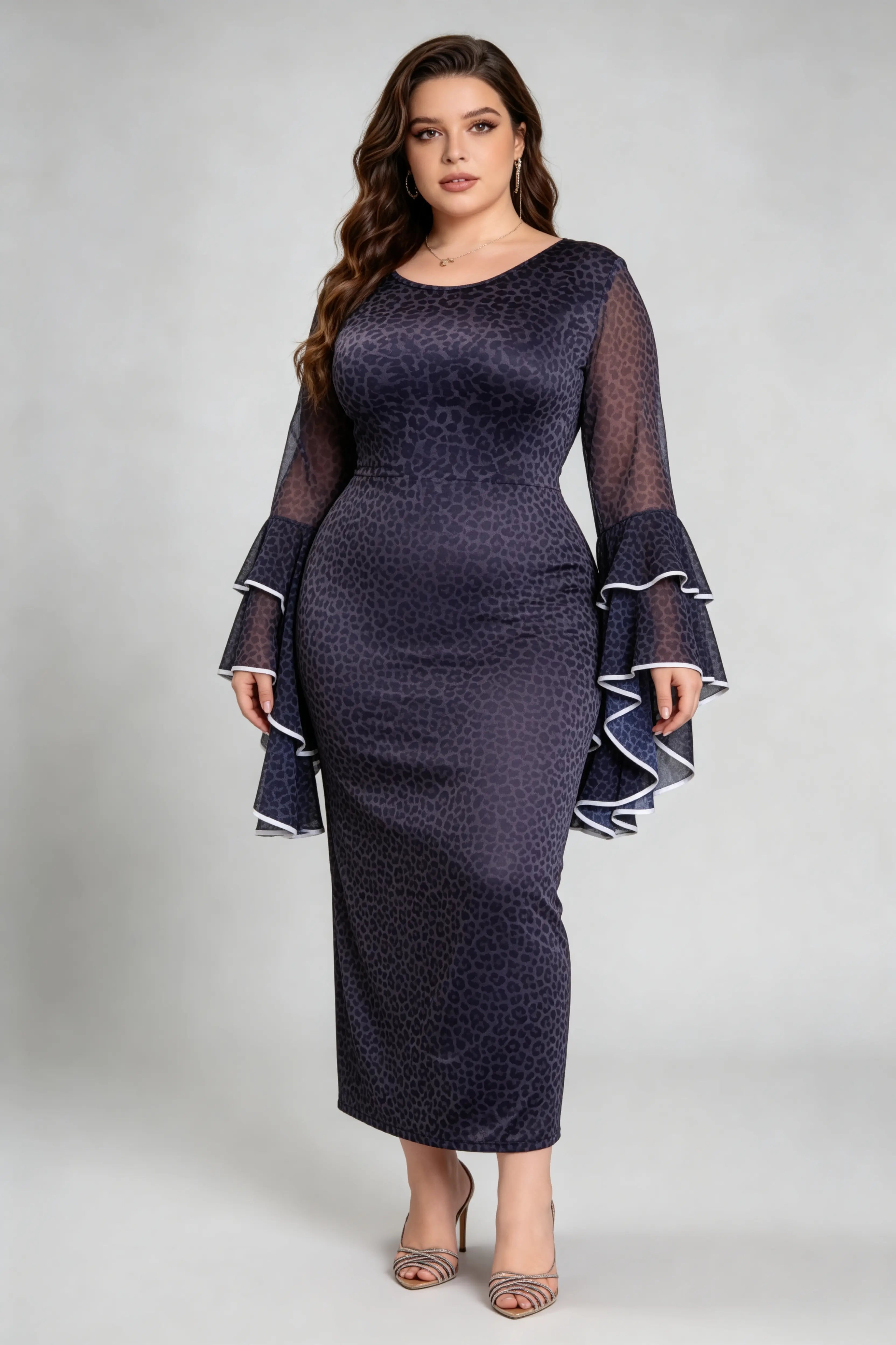 Curvy model wearing plus size black leopard print bodycon maxi dress with dramatic bell sleeves