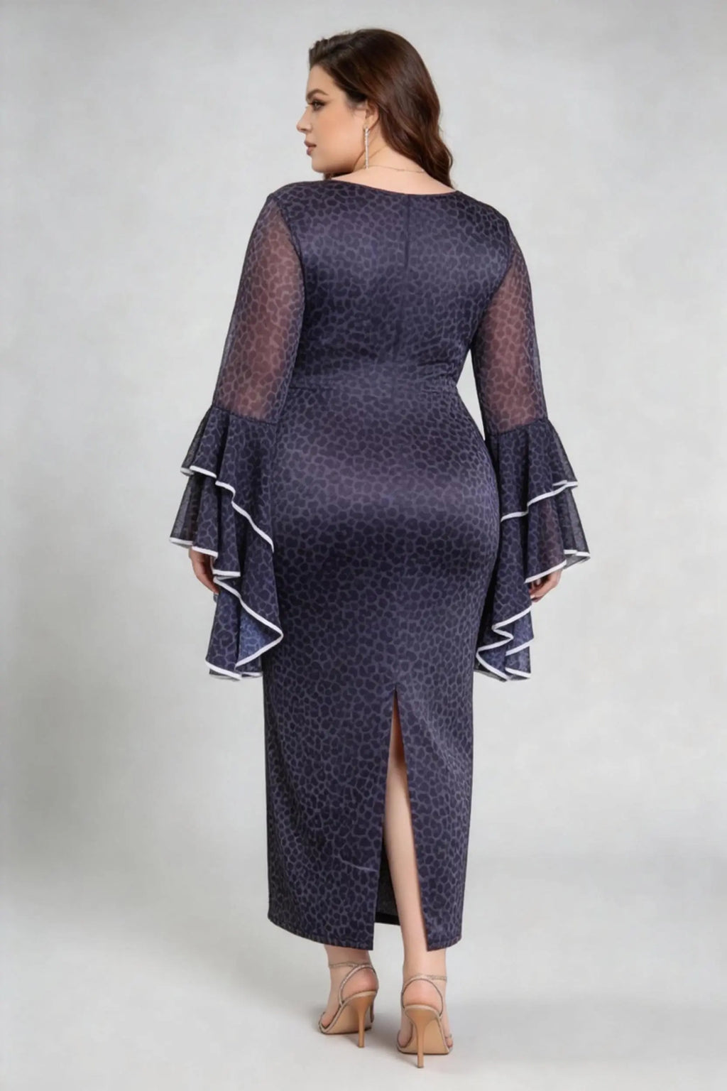 Curvy model wearing plus size black leopard print bodycon maxi dress with dramatic bell sleeves