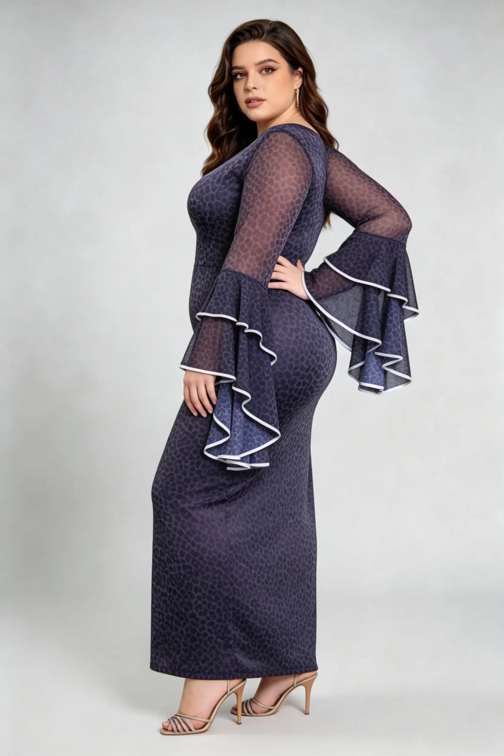 Curvy model wearing plus size black leopard print bodycon maxi dress with dramatic bell sleeves