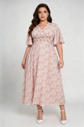 Curvy model wearing plus size pink floral v-neck midi dress, smocked waist flounce sleeve a-line chiffon casual summer dress