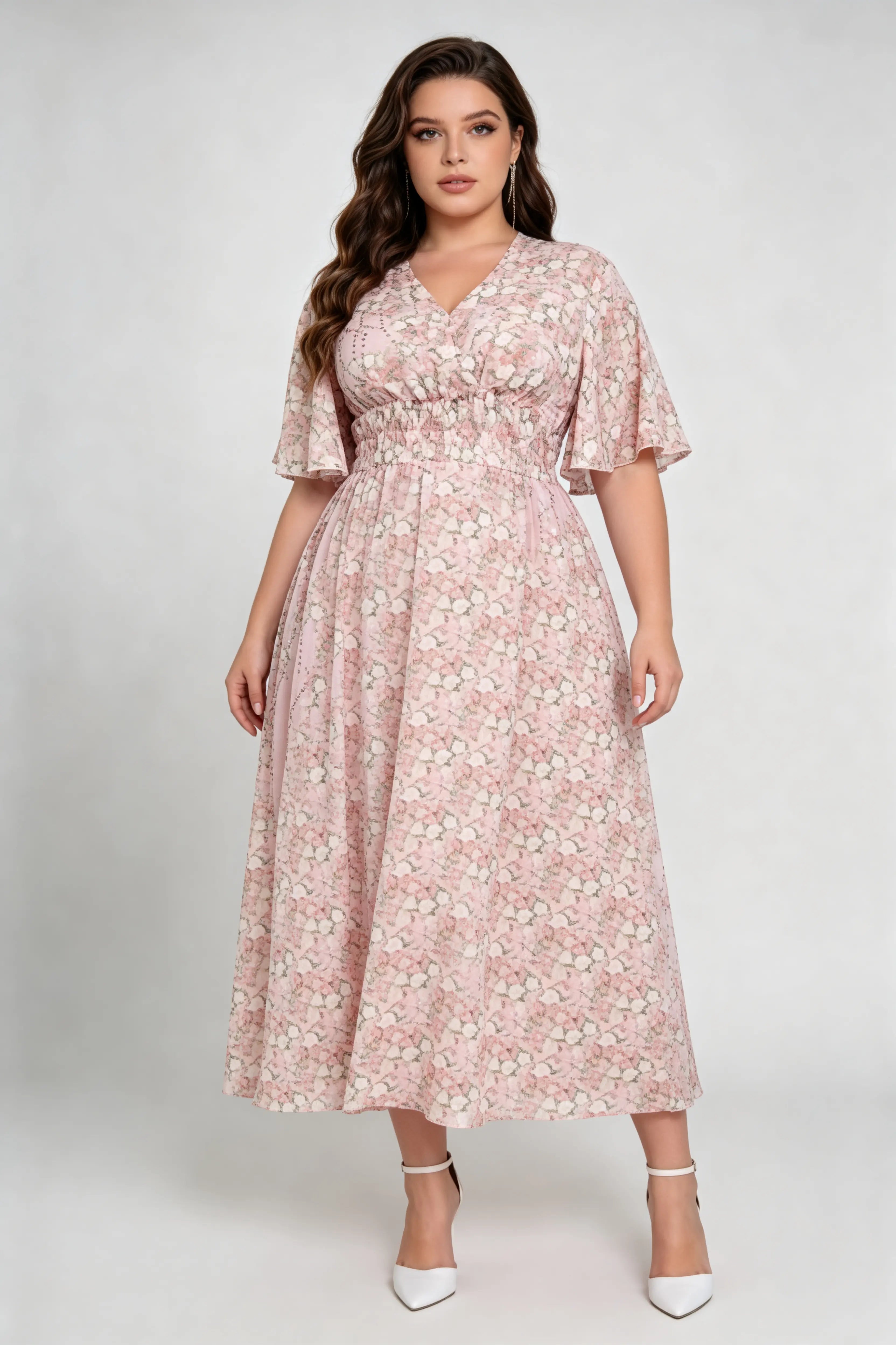 Curvy model wearing plus size pink floral v-neck midi dress, smocked waist flounce sleeve a-line chiffon casual summer dress