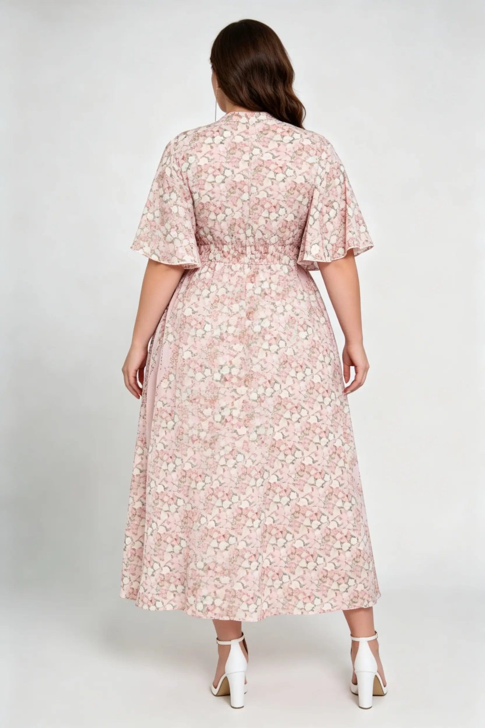 Curvy model wearing plus size pink floral v-neck midi dress, smocked waist flounce sleeve a-line chiffon casual summer dress