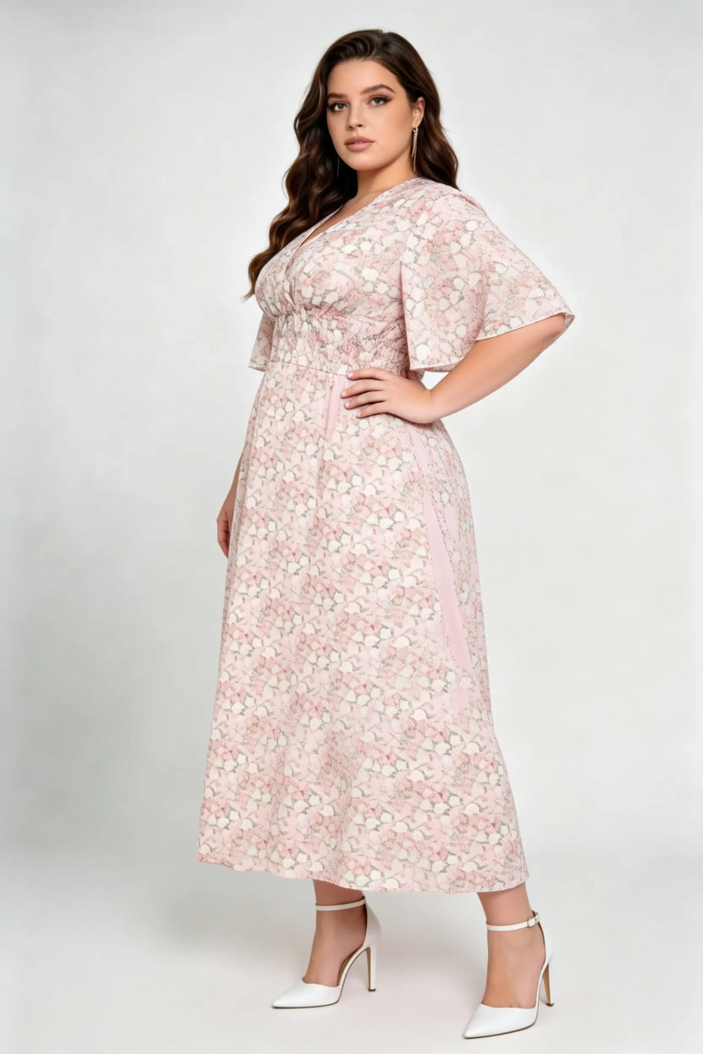 Curvy model wearing plus size pink floral v-neck midi dress, smocked waist flounce sleeve a-line chiffon casual summer dress