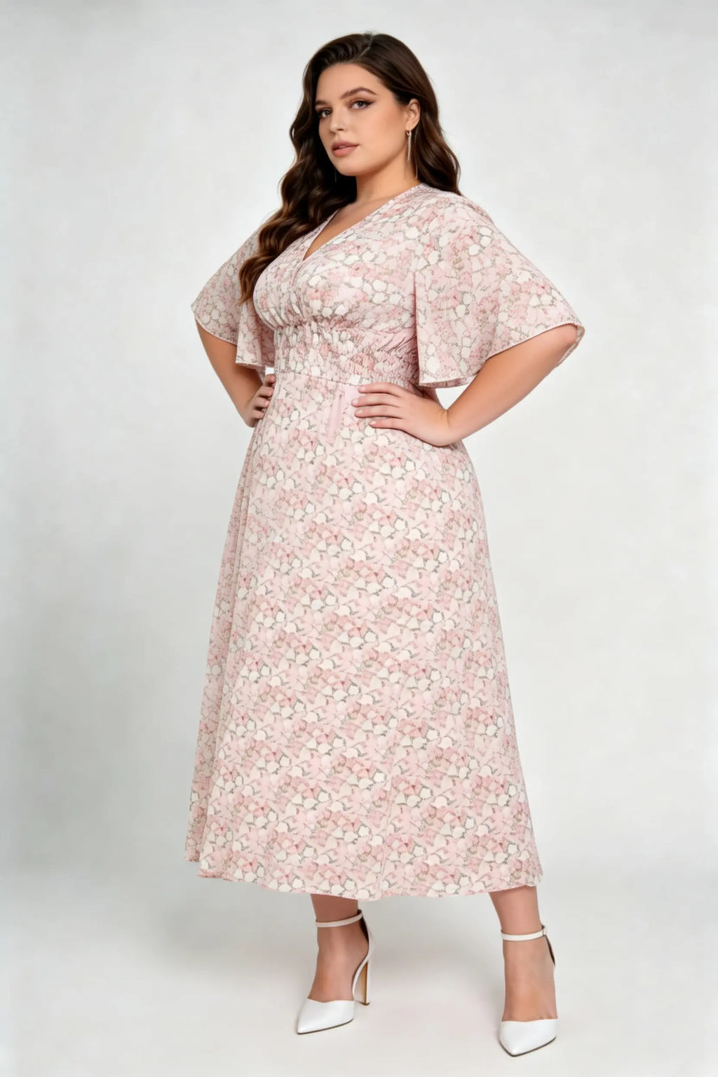 Curvy model wearing plus size pink floral v-neck midi dress, smocked waist flounce sleeve a-line chiffon casual summer dress