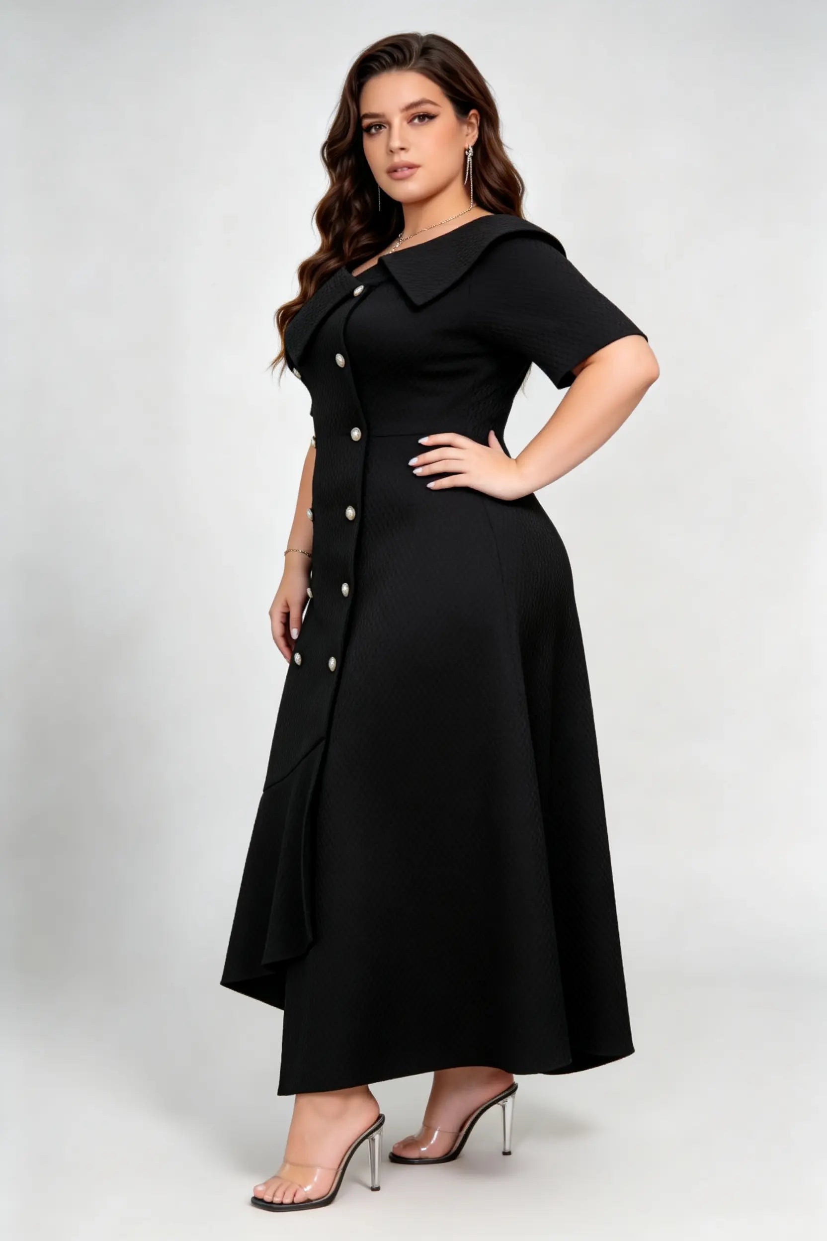 Curvy model wearing plus size black double-breasted asymmetric hem maxi dress, notched lapel short sleeve textured elegant workwear spring dress