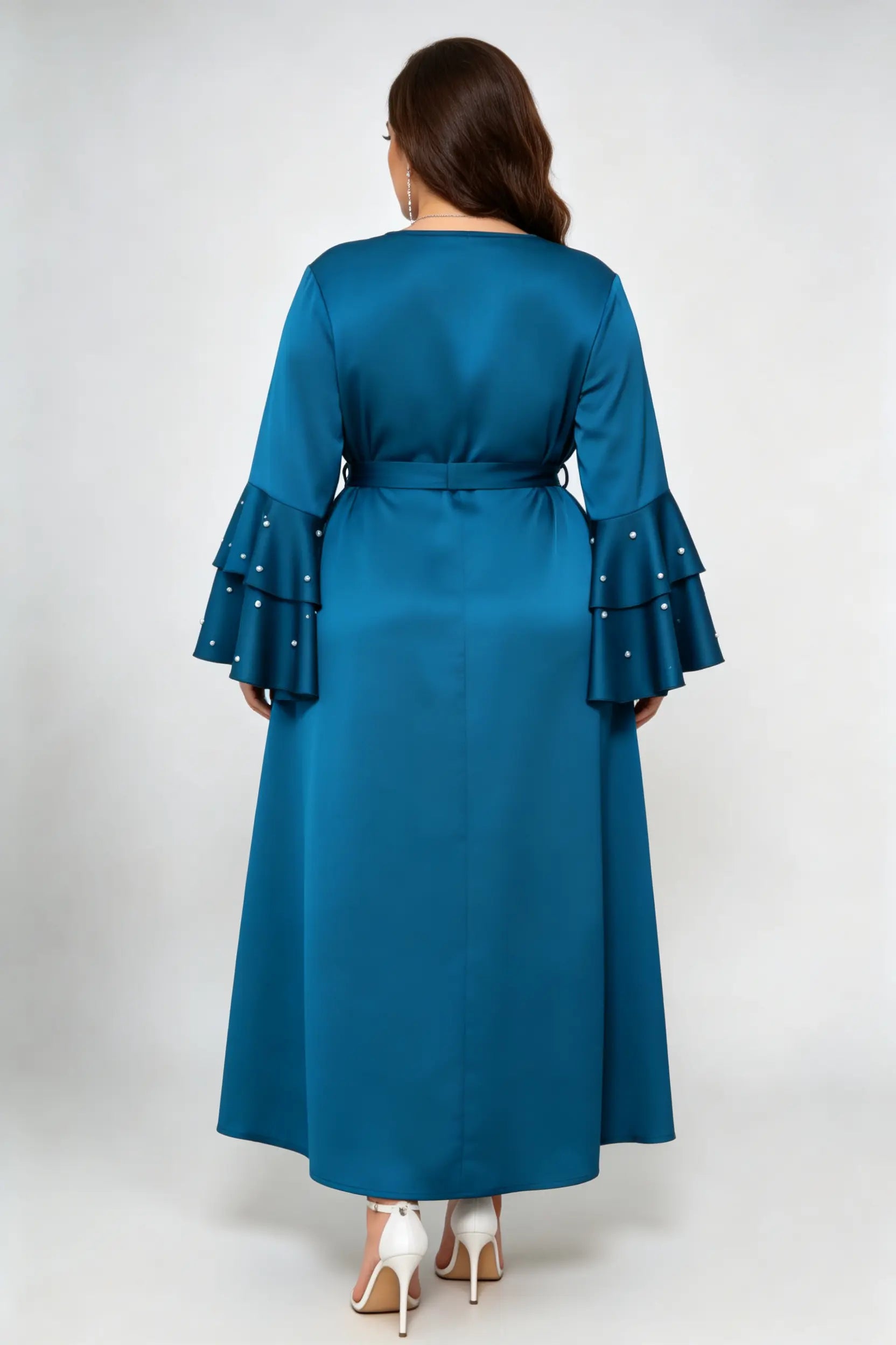 Curvy model wearing plus size teal blue satin maxi dress, tiered pearl flare sleeve round neck belted elegant evening dress