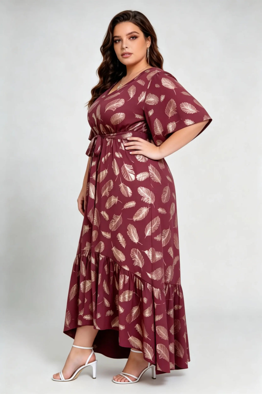 Curvy model wearing plus size wine red gold foil feather print maxi dress, v-neck flare sleeve high-low hem belted elegant summer dress