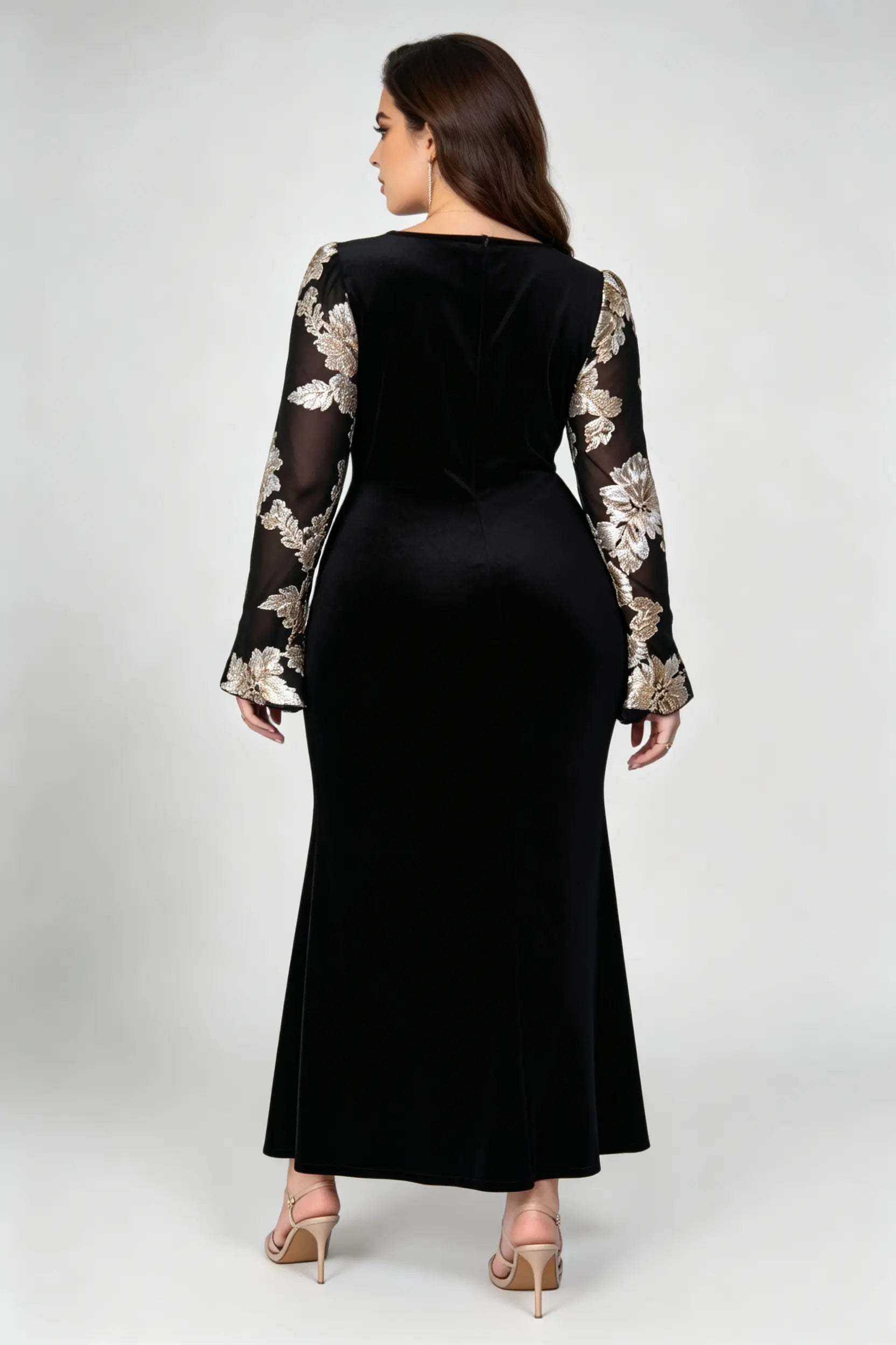 Curvy model wearing plus size black velvet mermaid maxi dress, square neck sheer bell sleeve with gold floral embroidery formal evening dress