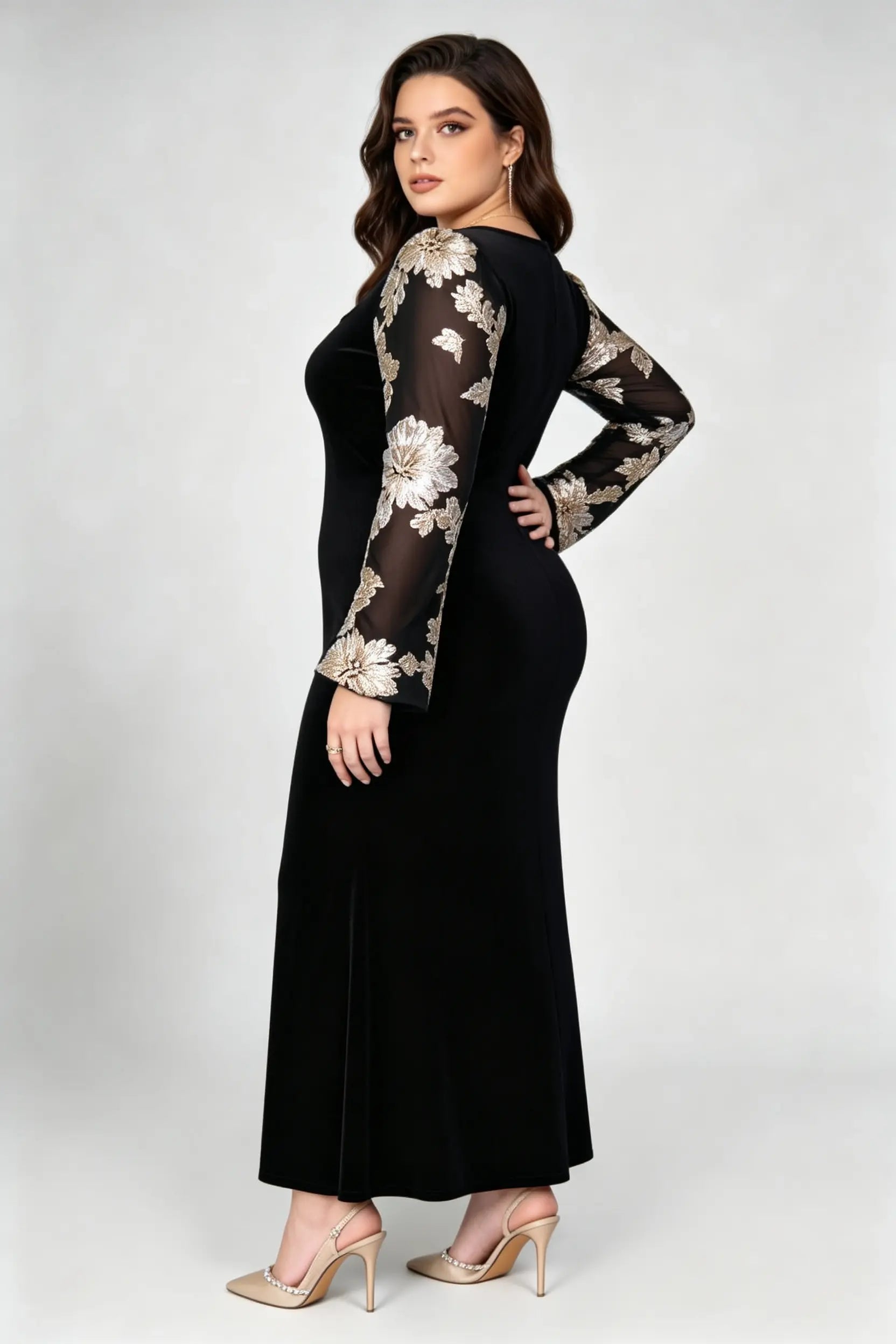 Curvy model wearing plus size black velvet mermaid maxi dress, square neck sheer bell sleeve with gold floral embroidery formal evening dress