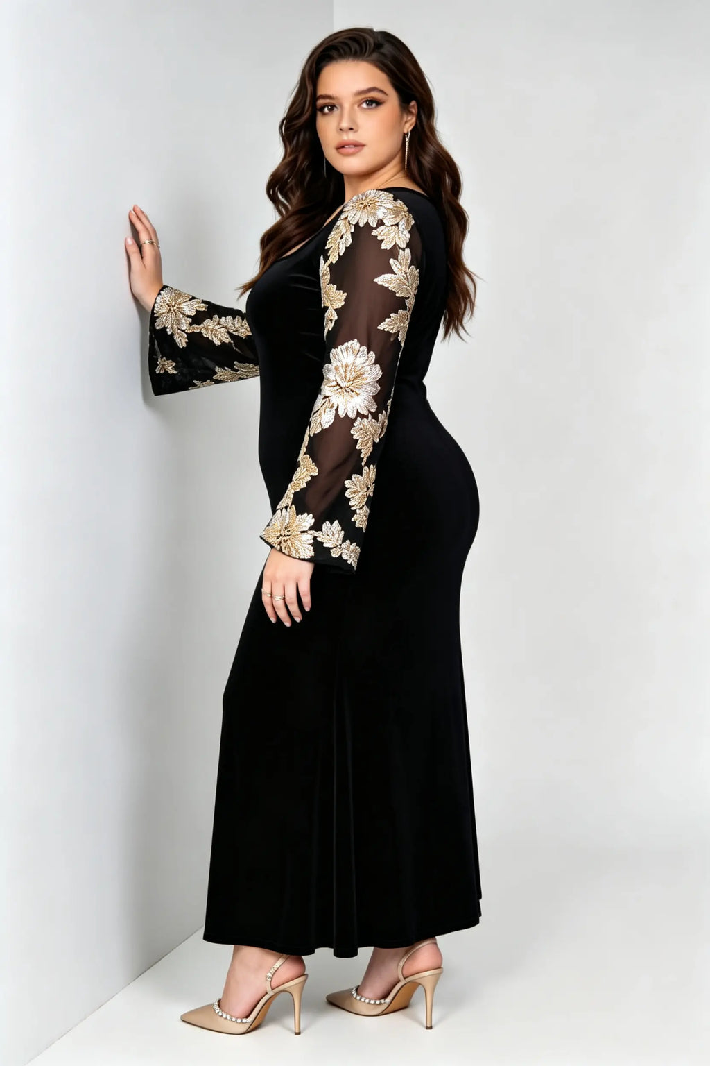 Curvy model wearing plus size black velvet mermaid maxi dress, square neck sheer bell sleeve with gold floral embroidery formal evening dress