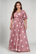 Curvy model wearing plus size pink polka dot pleated maxi dress, v-neck flutter sleeve belted chiffon a-line elegant summer dress