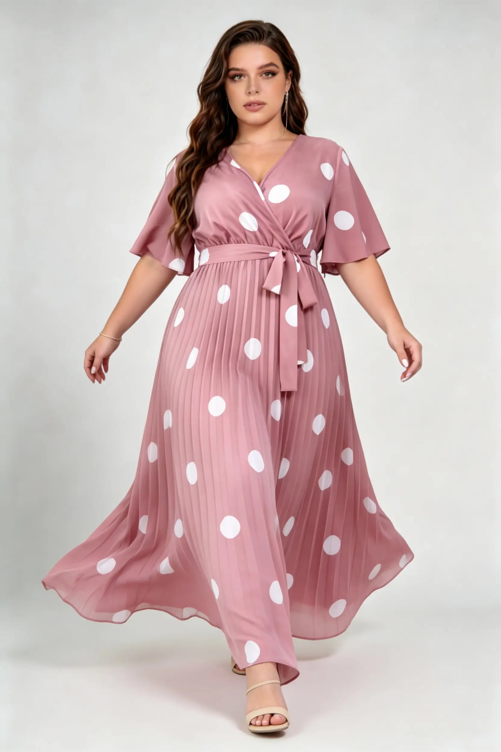 Curvy model wearing plus size pink polka dot pleated maxi dress, v-neck flutter sleeve belted chiffon a-line elegant summer dress
