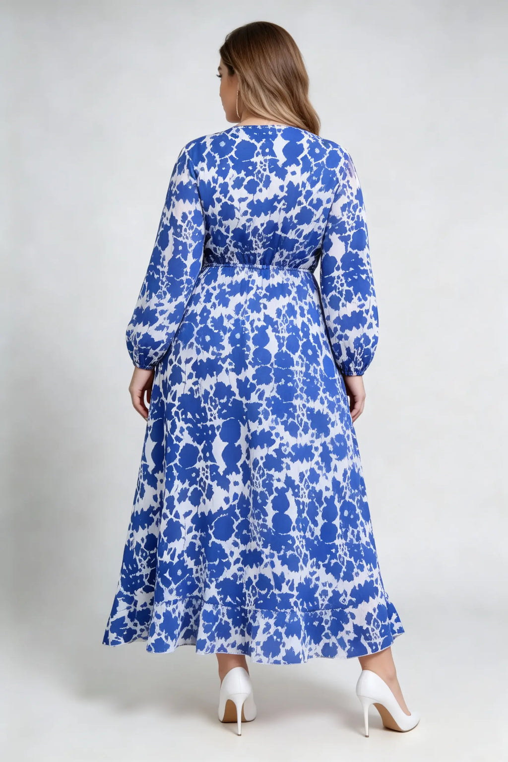 Curvy model wearing plus size blue floral print wrap maxi dress, v-neck long sleeve high-low ruffle hem a-line elegant casual dress