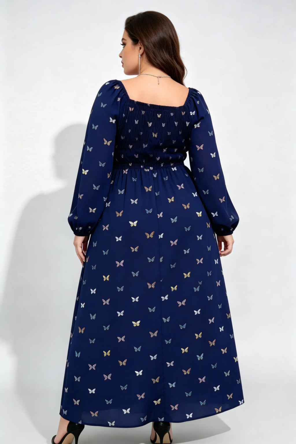 Curvy model wearing plus size navy blue butterfly print maxi dress, square neck smocked long sleeve a-line casual dress