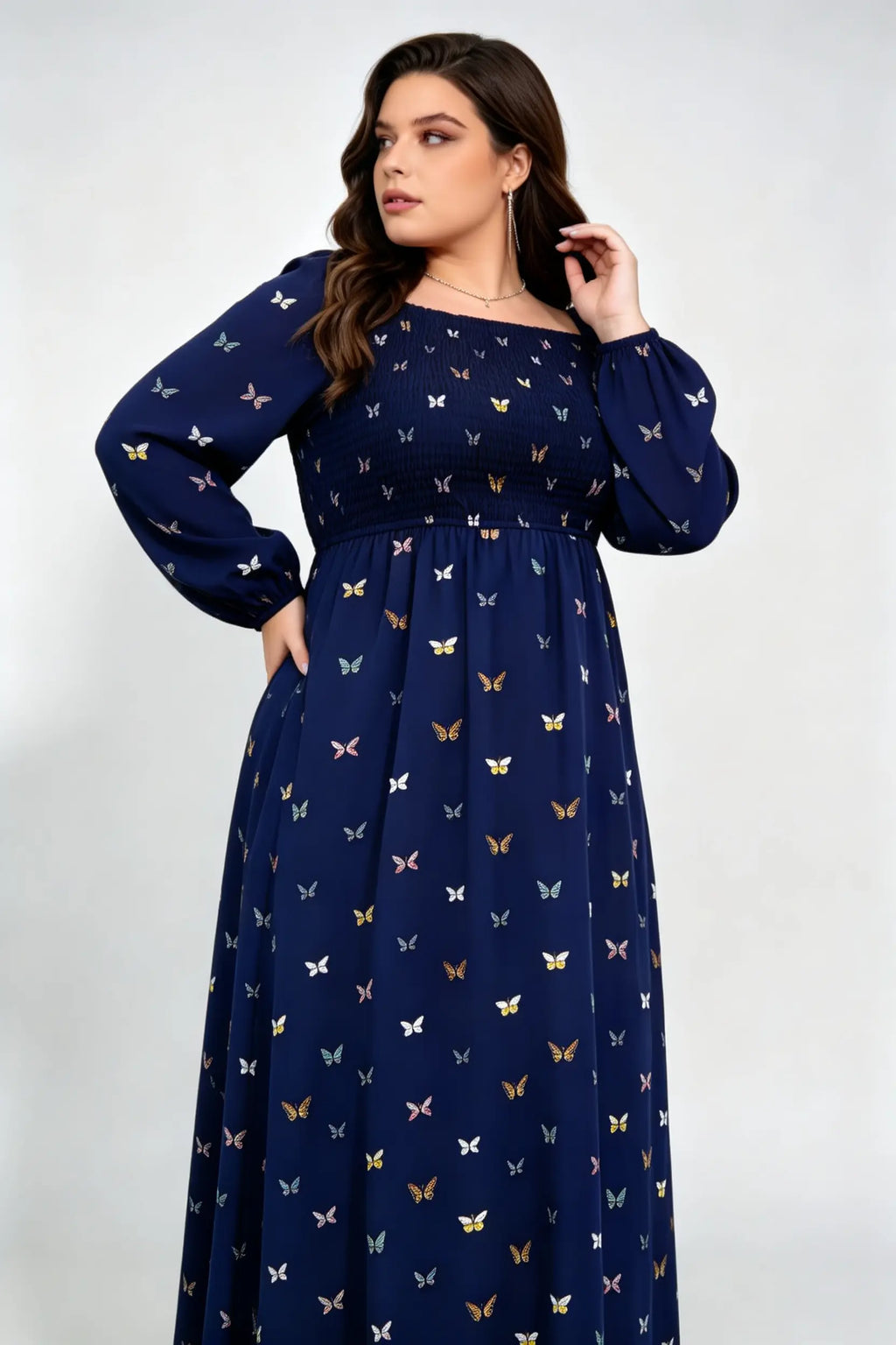 Curvy model wearing plus size navy blue butterfly print maxi dress, square neck smocked long sleeve a-line casual dress