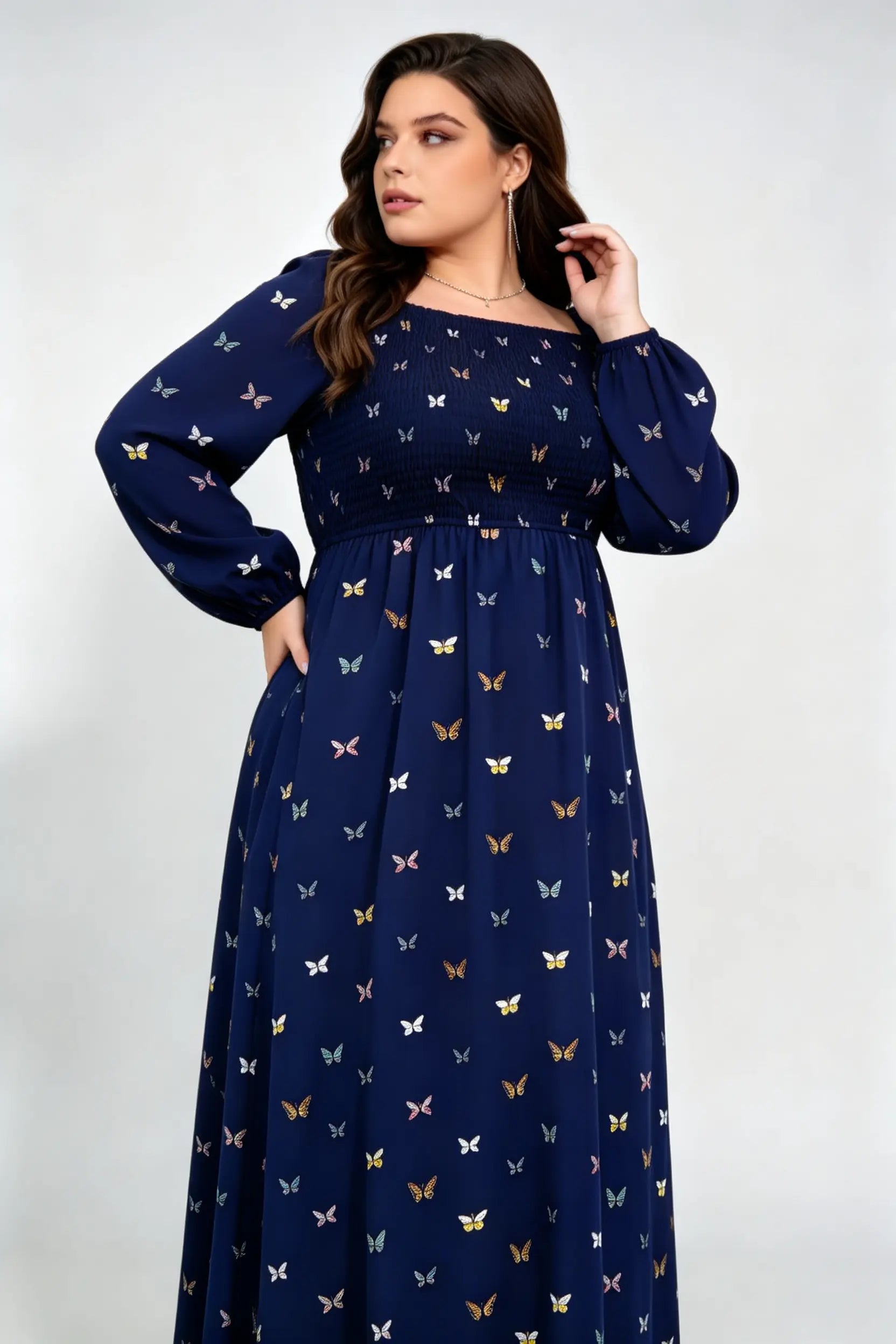 Curvy model wearing plus size navy blue butterfly print maxi dress, square neck smocked long sleeve a-line casual dress