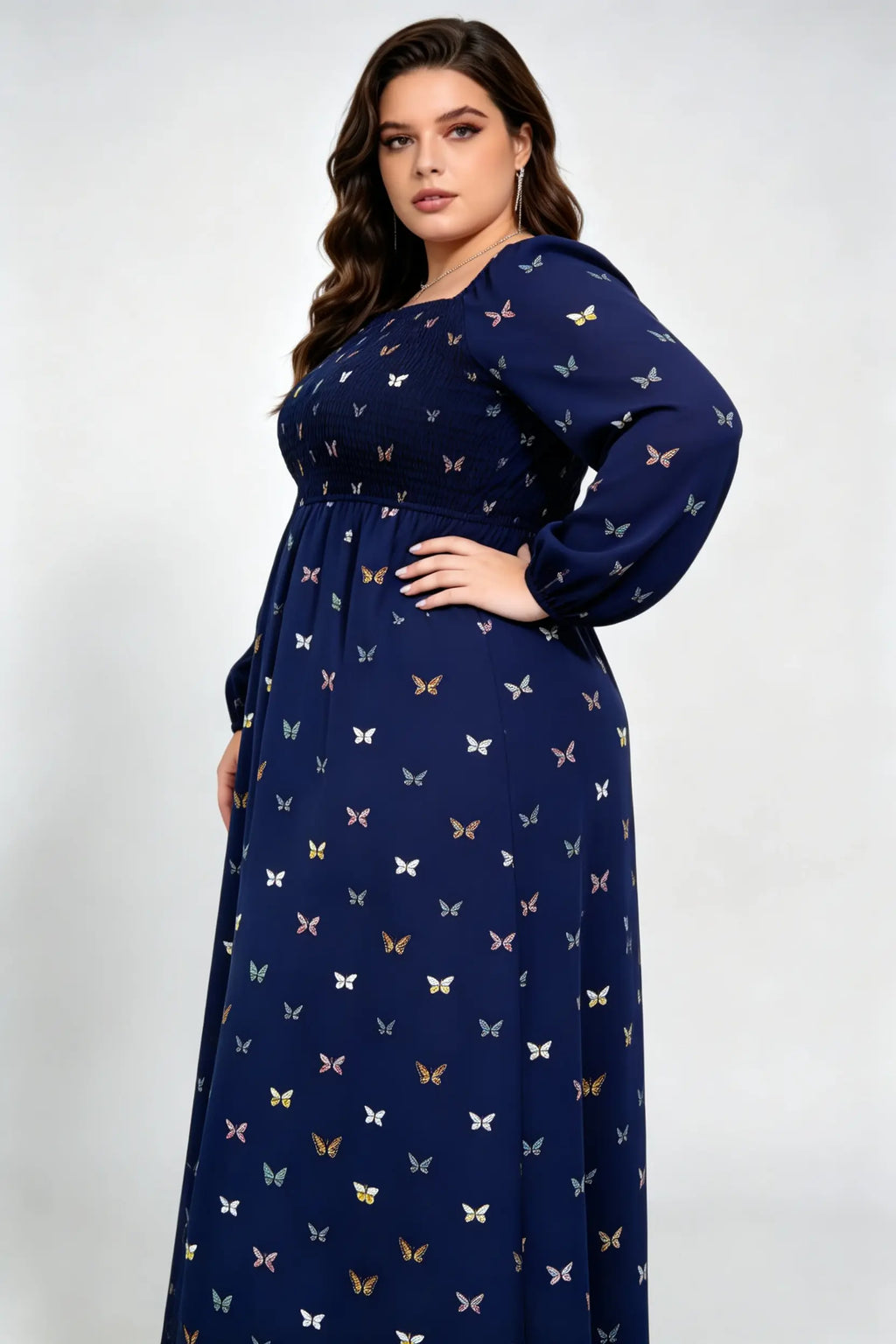 Curvy model wearing plus size navy blue butterfly print maxi dress, square neck smocked long sleeve a-line casual dress