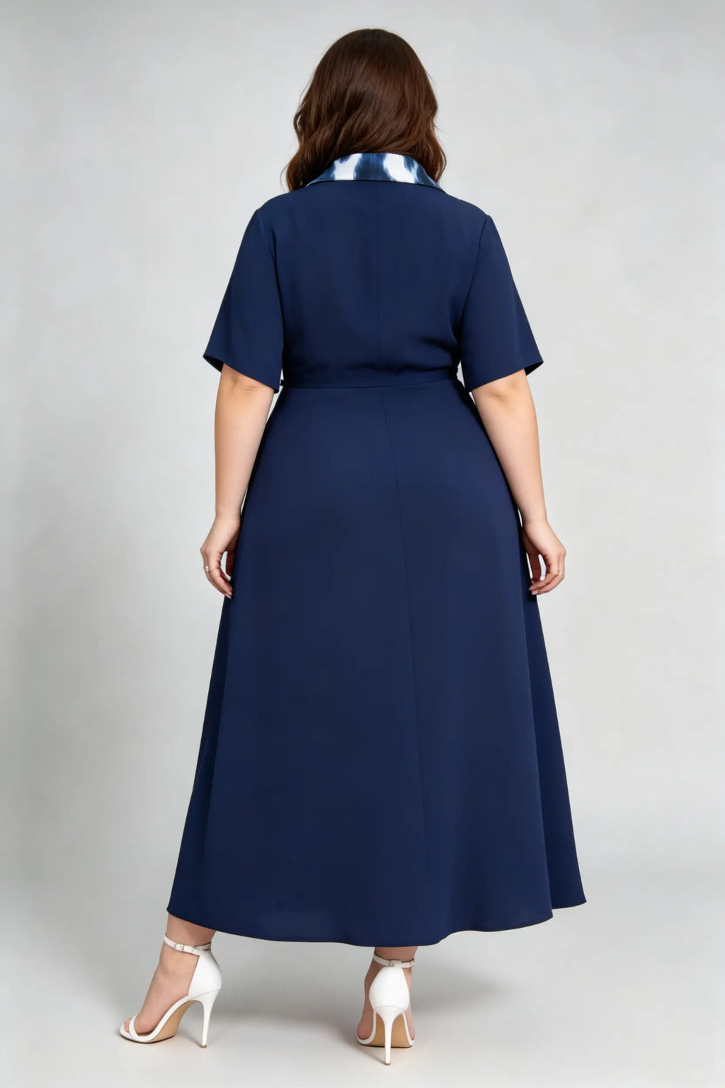 Curvy model wearing plus size navy blue tie-dye pleated midi dress, suit collar short sleeve belted a-line work dress