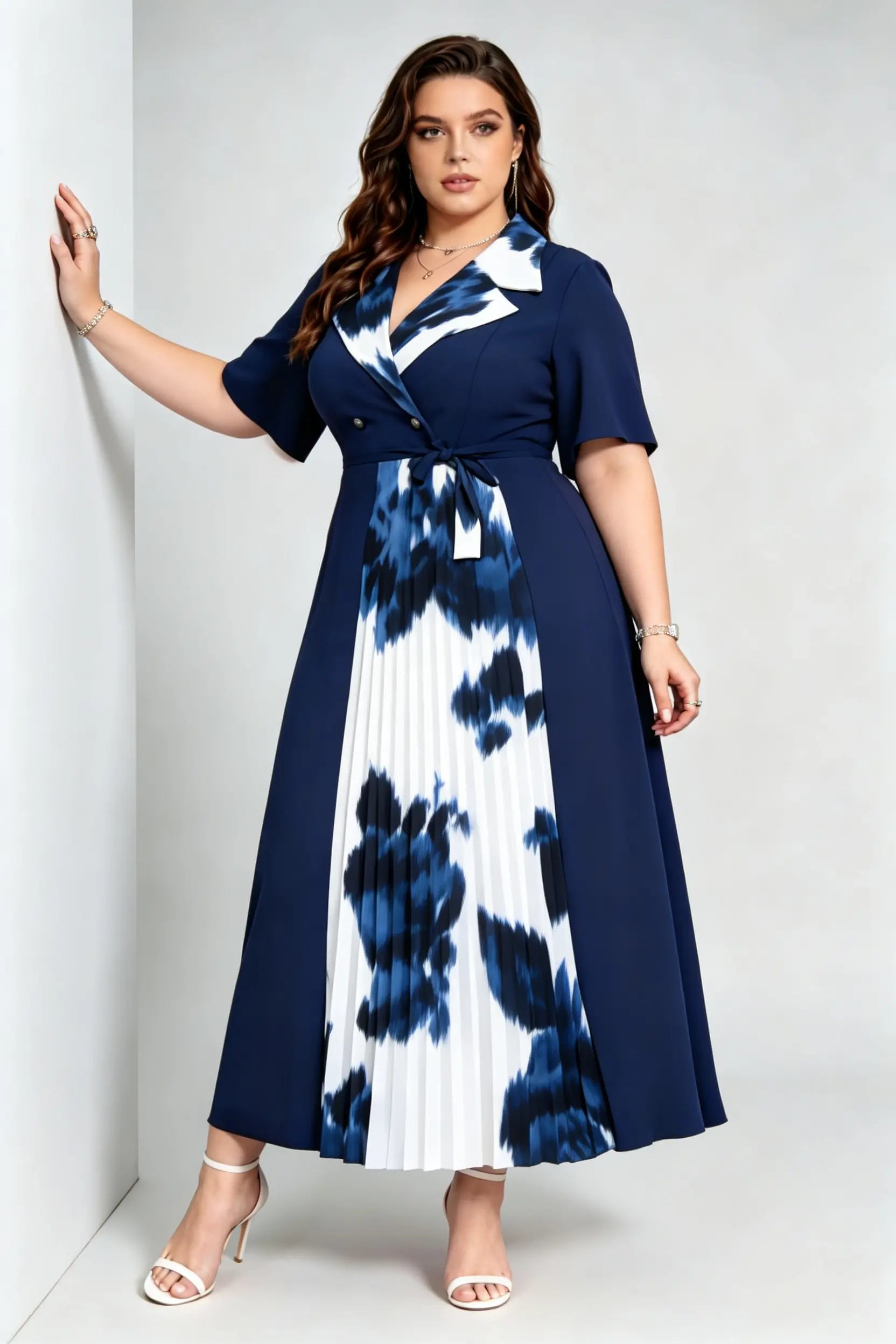 Curvy model wearing plus size navy blue tie-dye pleated midi dress, suit collar short sleeve belted a-line work dress