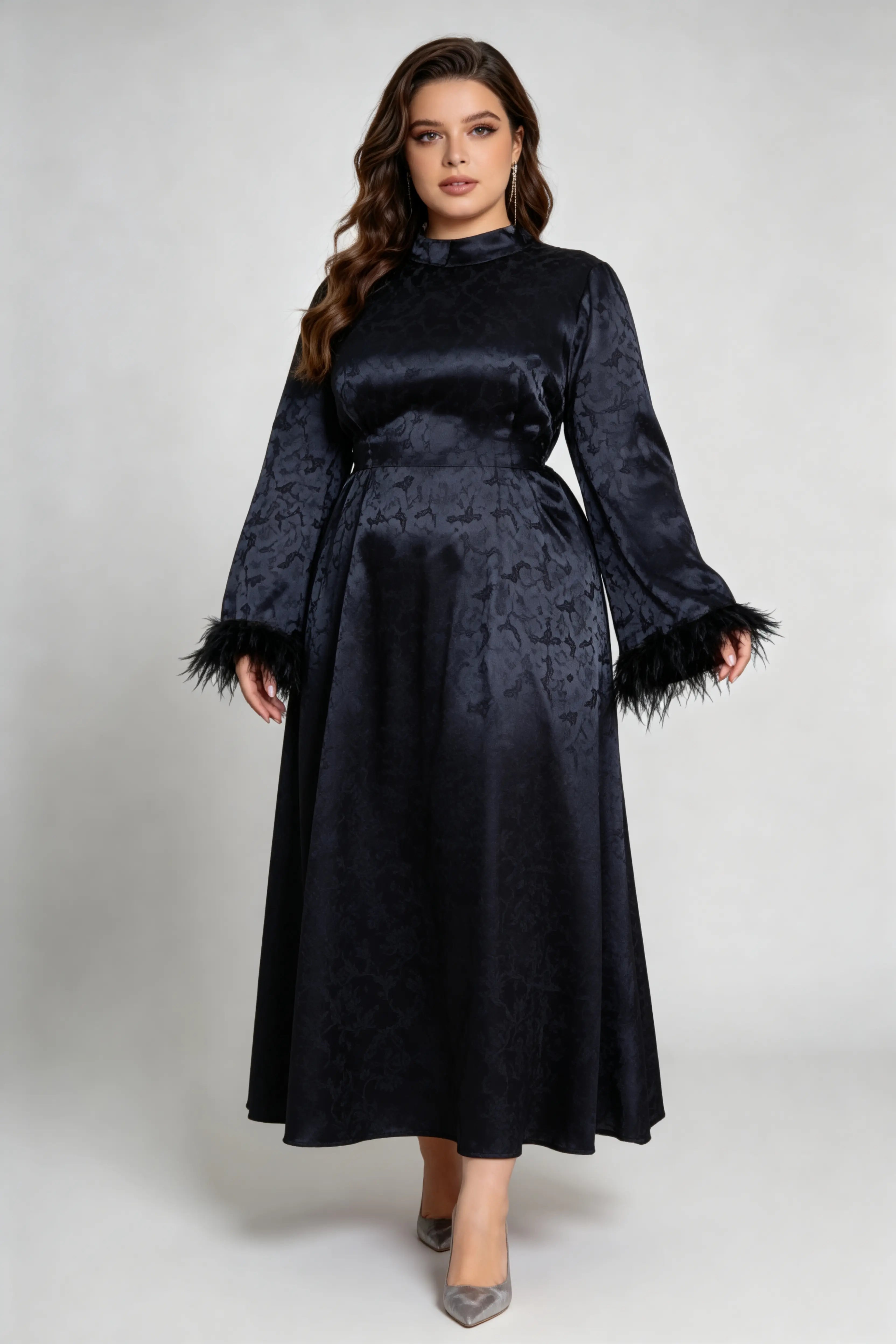 Curvy model wearing plus size black jacquard feather cuff maxi dress, stand collar long sleeve back tie a-line formal dress