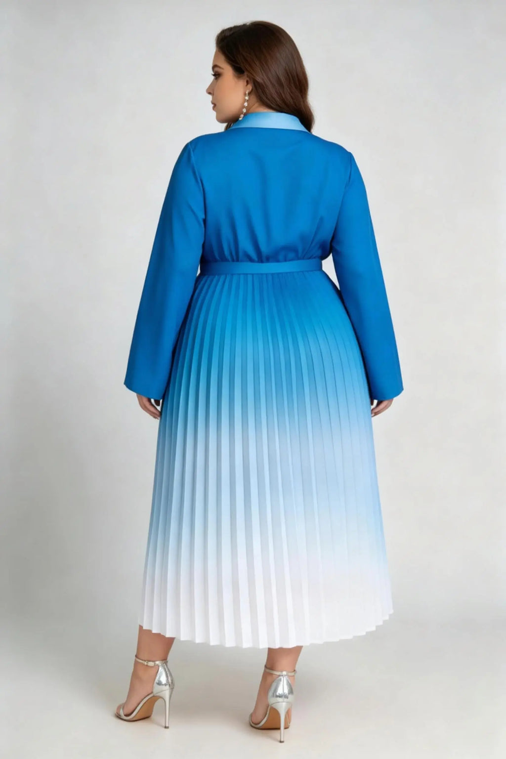 Curvy model wearing plus size blue gradient pleated midi dress, lapel collar wrap v-neck long sleeve belted a-line work dress